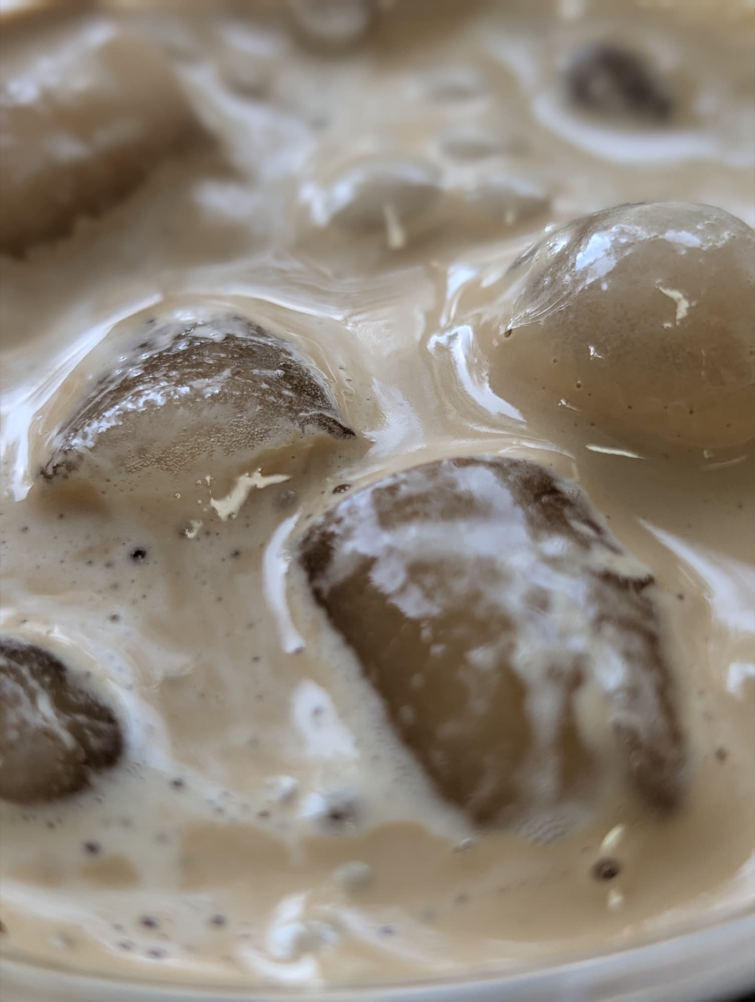 Close-up of honey whipped coffee swirling over ice