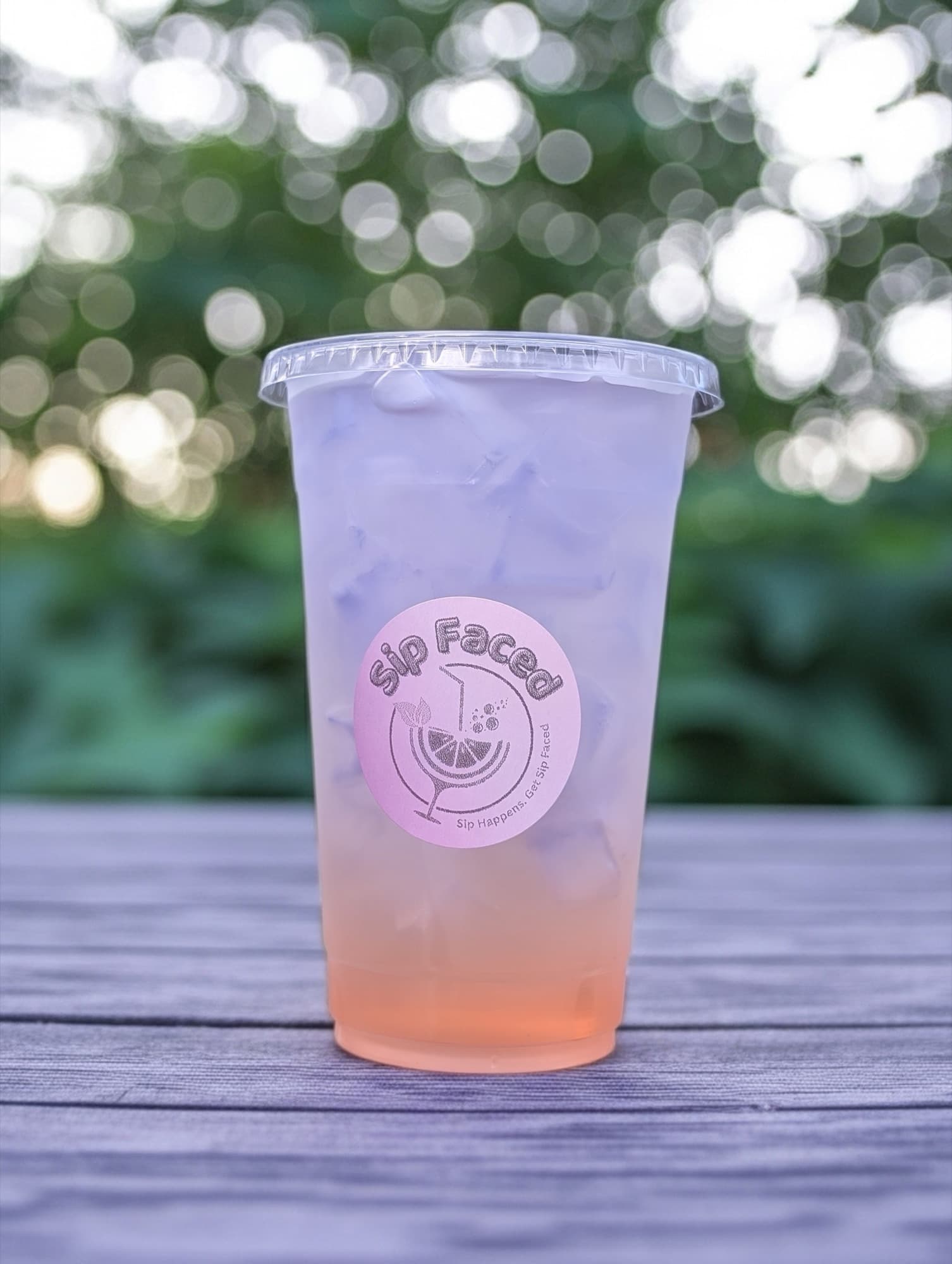 Bright pink Sip Faced lemonade with bokeh background