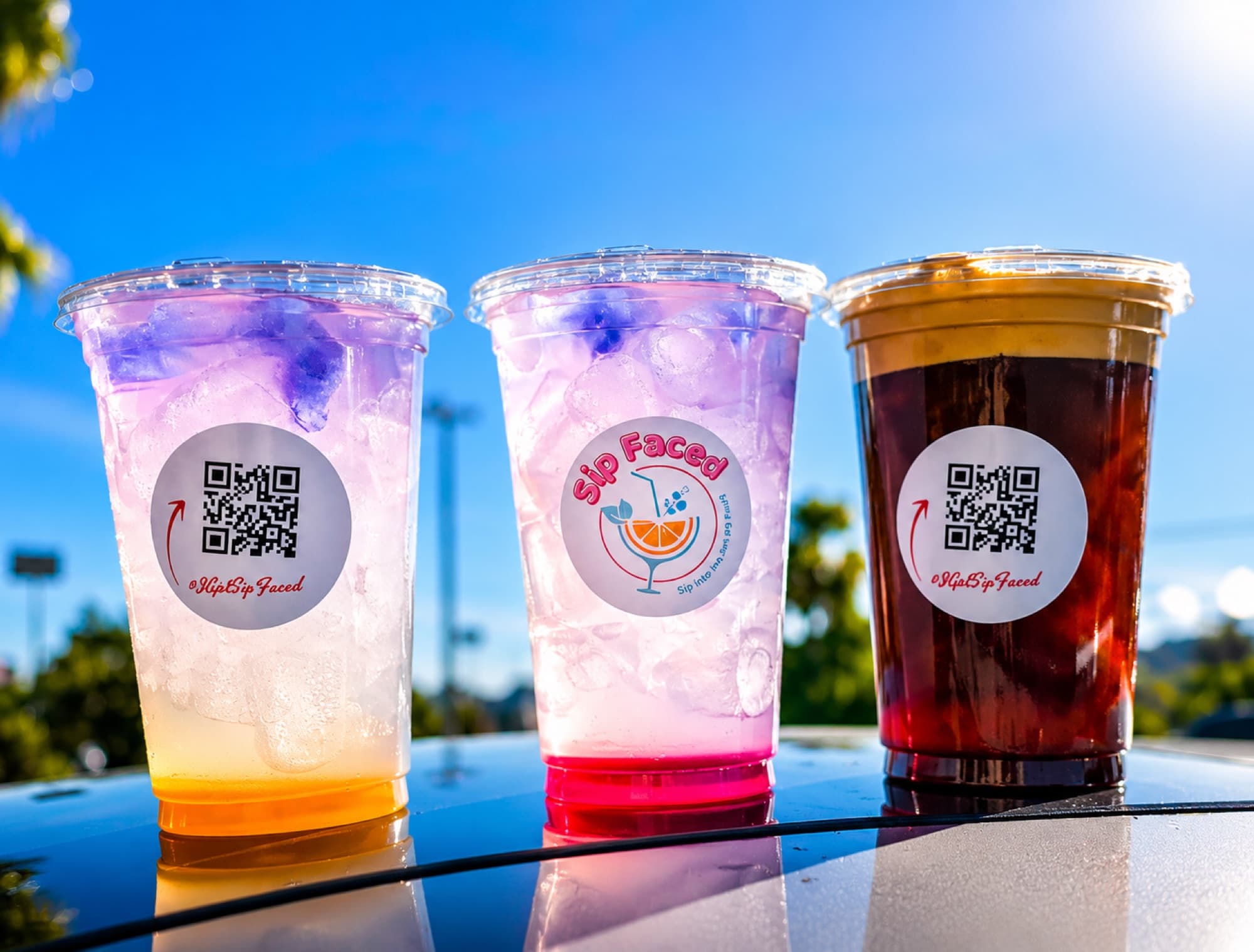 Three colorful Sip Faced drinks lined up — yellow, red, and cold brew